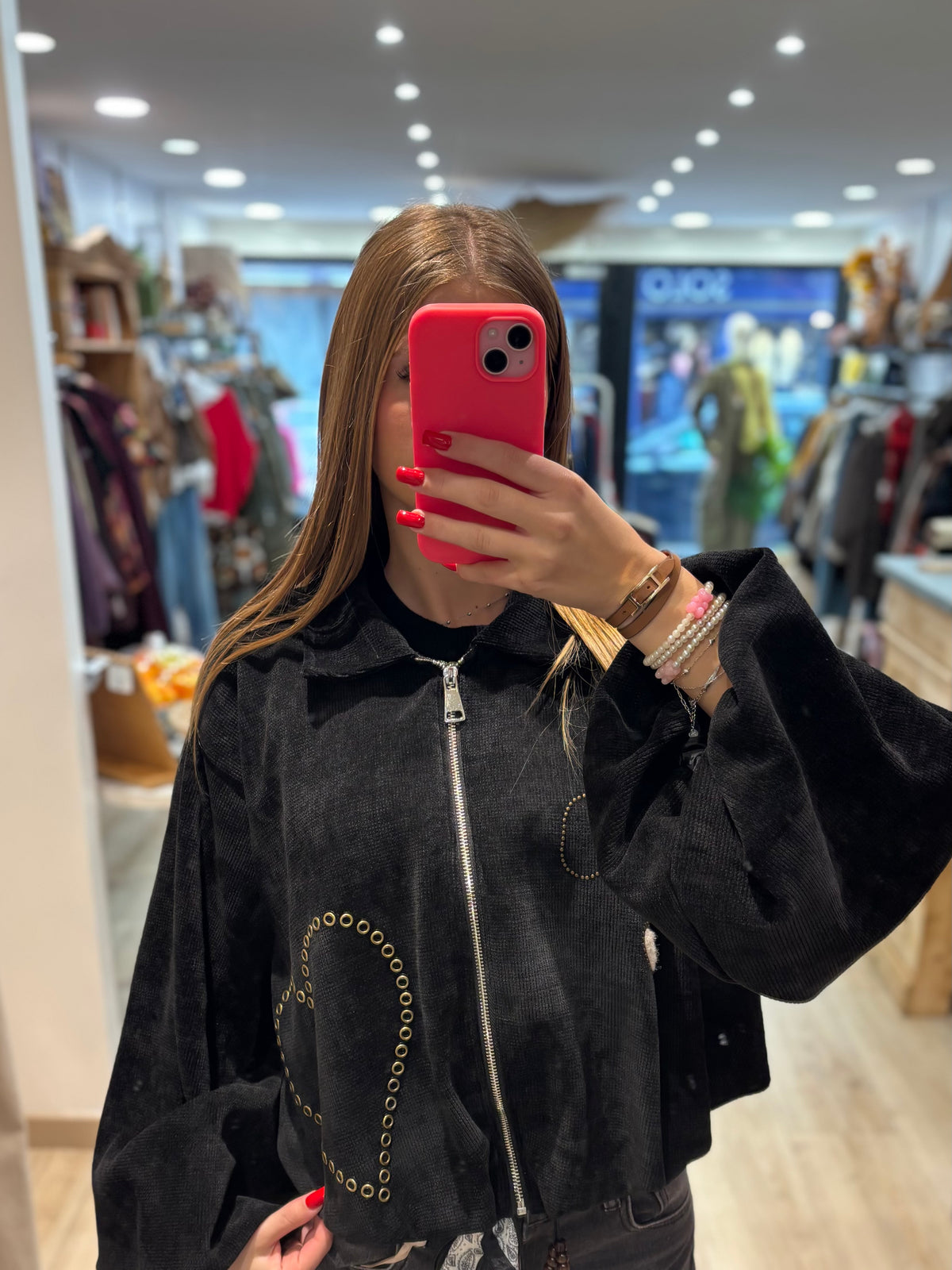 Veste courte zippée à œillets décoratifs
